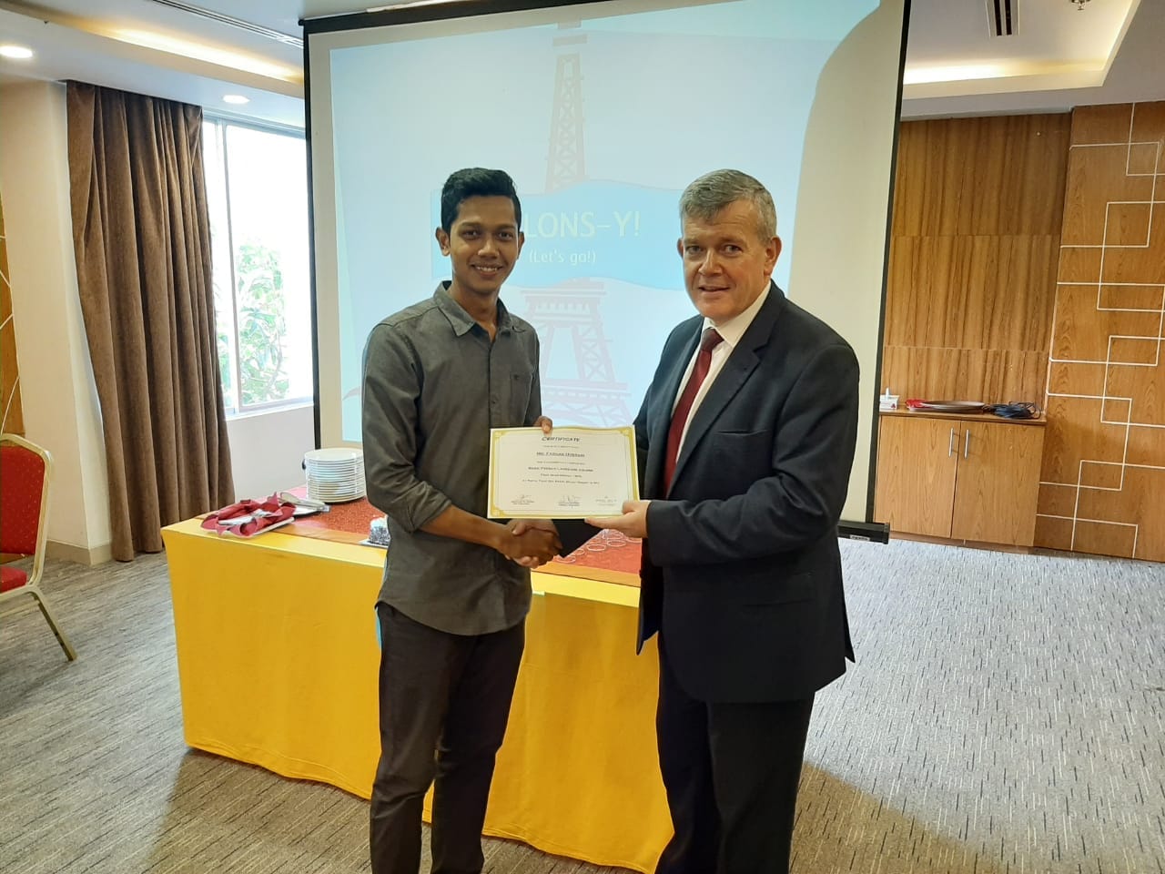 Stephane Meunier presenting a language course certificate at Royal Tulip Sea Pearl, Cox's Bazar